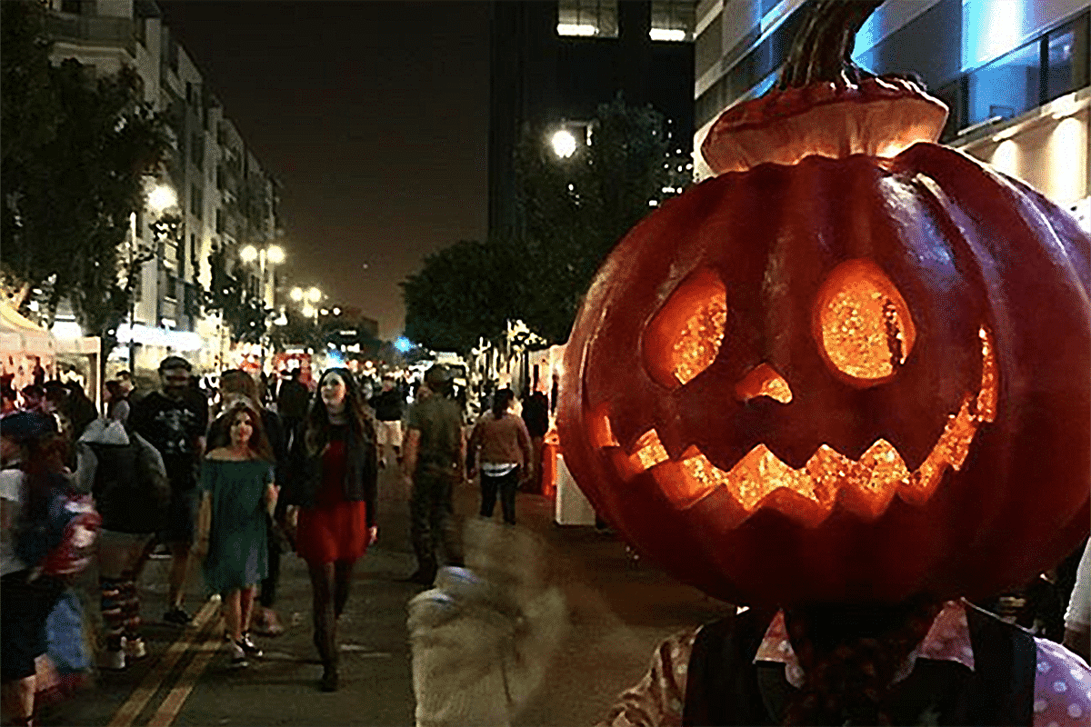 A giant jack-o'-lantern costume in the crowd at an early Haunted Little Tokyo block party