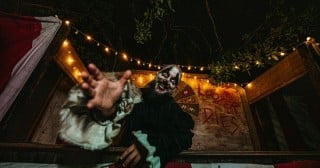 A scareactor reaches for guests at A Petrified Forest scream park in Altamonte Springs, Florida