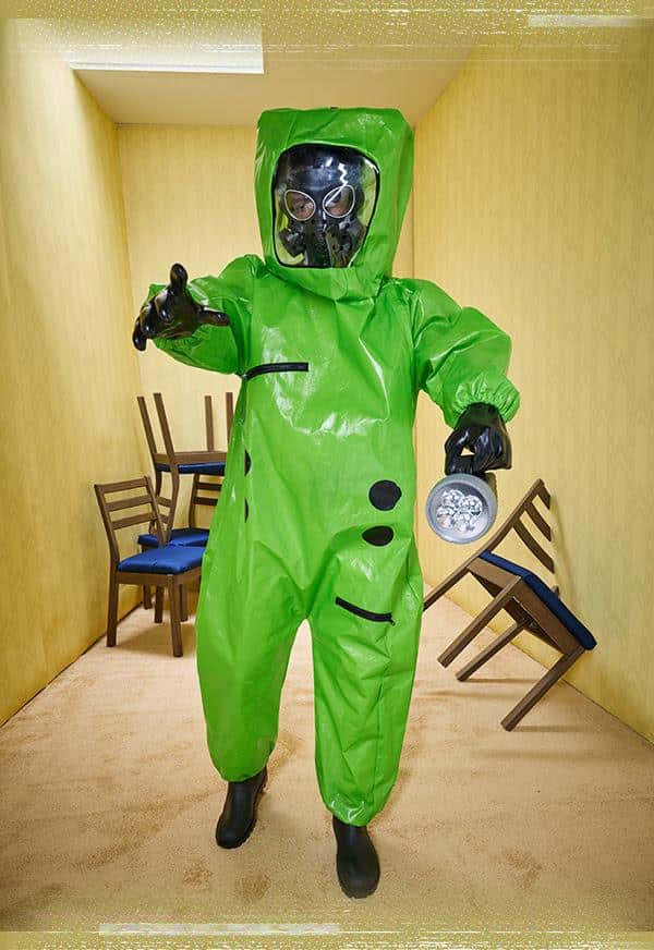 Green Async Hazmat Suit Backrooms costume staged in a liminal room