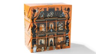 Three orange Boojangles Bite Boxes stacked so their printed art forms a haunted house, with a roof, bats and a skeleton on the top box and a porch with a ghost and jack-o'-lanterns on the bottom box