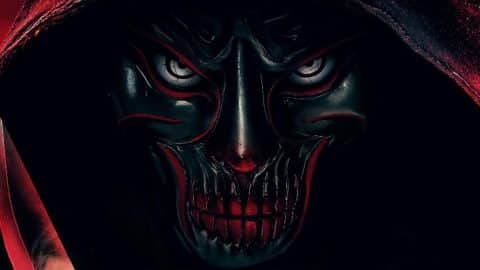 A hooded killer in a black skull mask with red markings and bared teeth, with the edge of a knife at the left