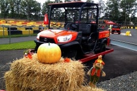 Fall decorations, a pumpkin, and a Kubota utility vehicle at Diggerland USA's Diggerfest