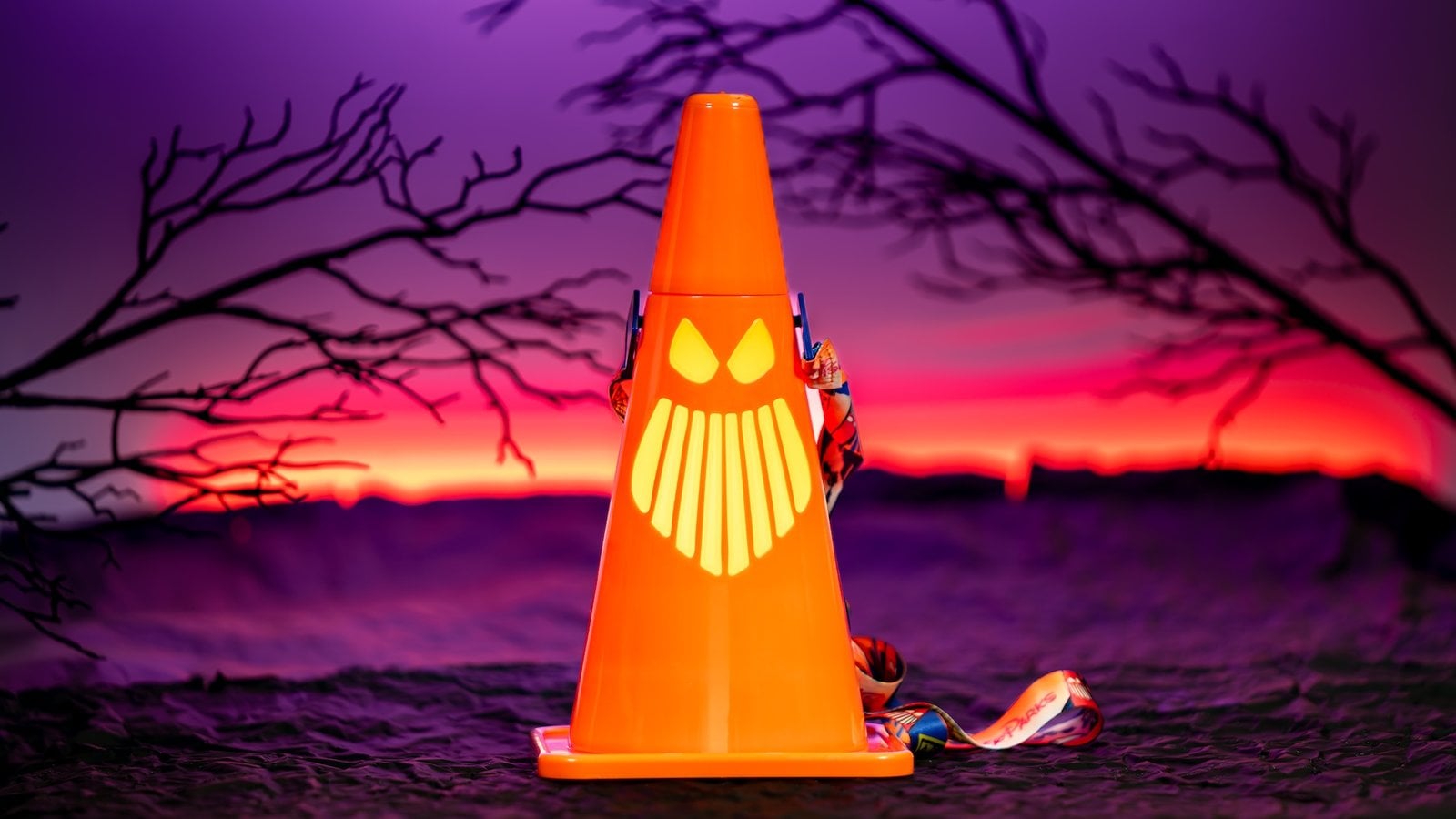 Orange Cars Land Cozy Cone sipper with a glowing ghostly grin