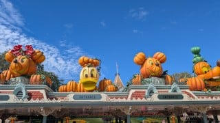 Mickey, Donald, and Goofy pumpkins above the Disneyland park entrance during Halloween Time 2026