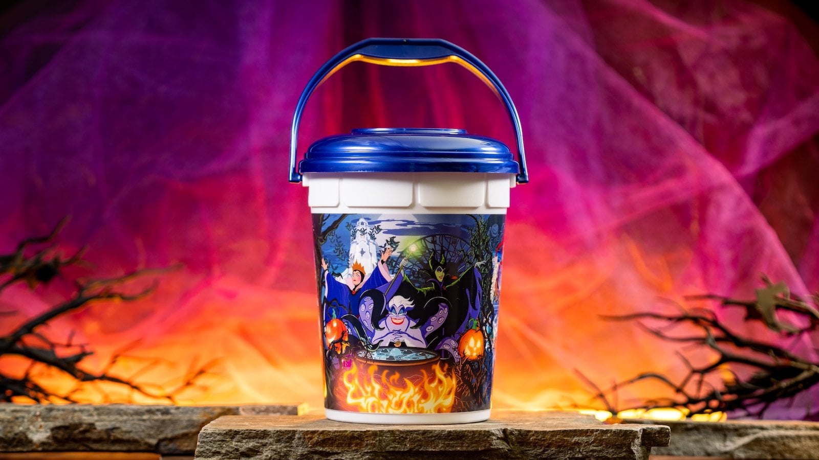 Disneyland's 2026 Halloween popcorn bucket with Ursula, Maleficent, and the Evil Queen around a flaming cauldron