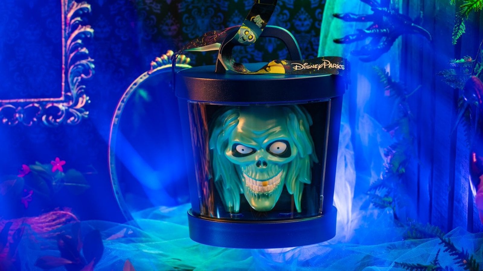 Haunted Mansion Hatbox Ghost popcorn bucket with the ghost's green face in the hatbox