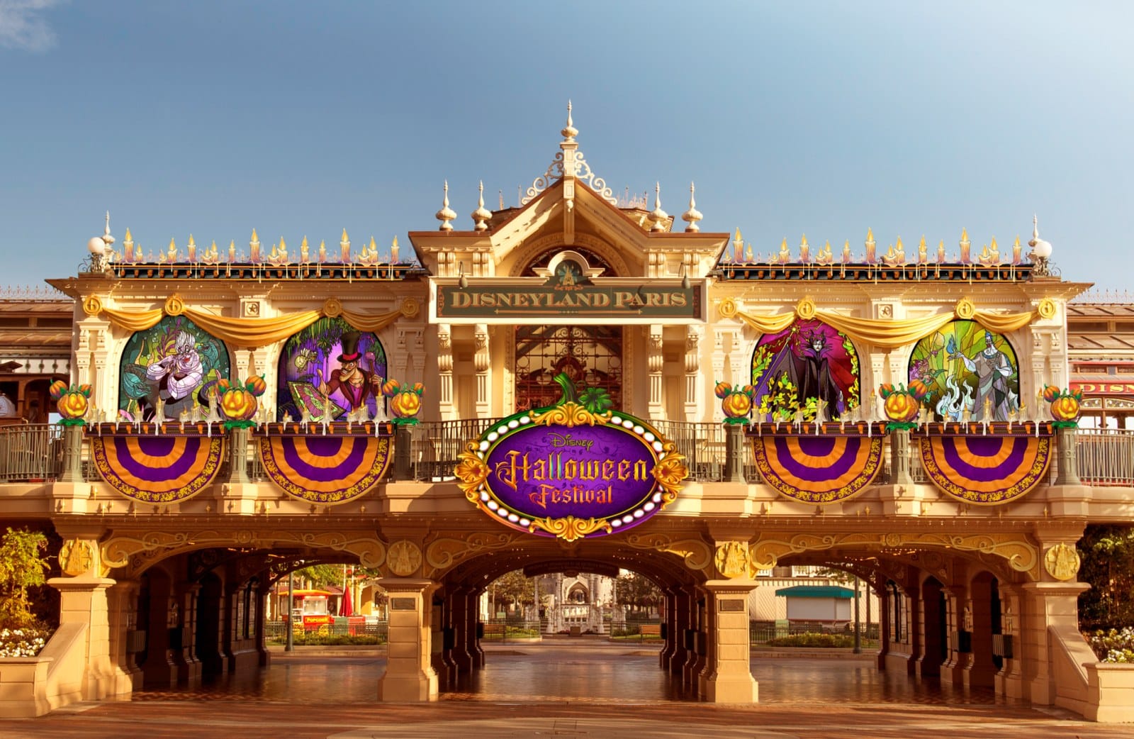 Main Street station at Disneyland Paris with Disney Villains stained-glass windows and Halloween Festival banners