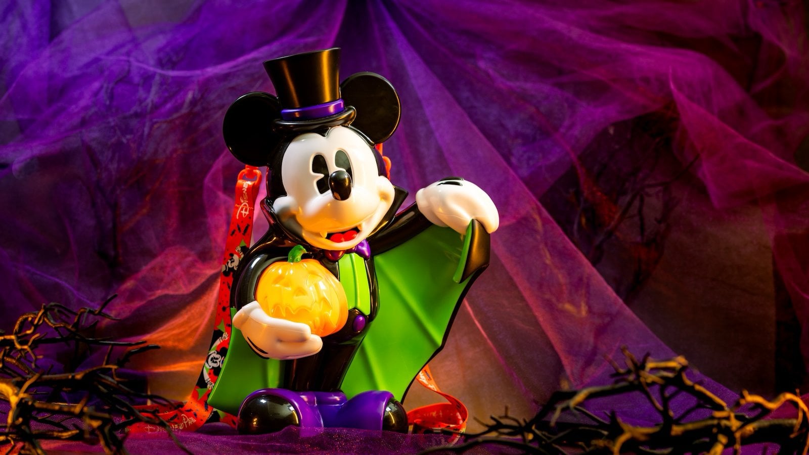 Vampire Mickey Mouse popcorn bucket at Disneyland, Mickey in a cape and top hat holding a glowing jack-o'-lantern