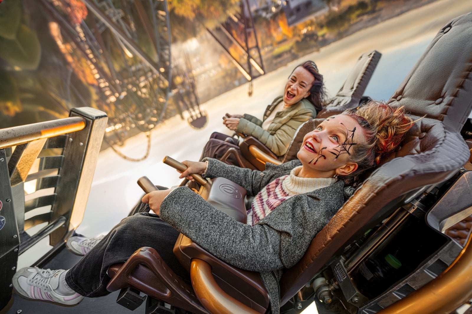 Riders in Halloween face paint on a Europa-Park roller coaster