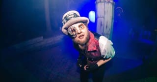 A top-hat scareactor in fog at Kings Dominion Halloween Haunt