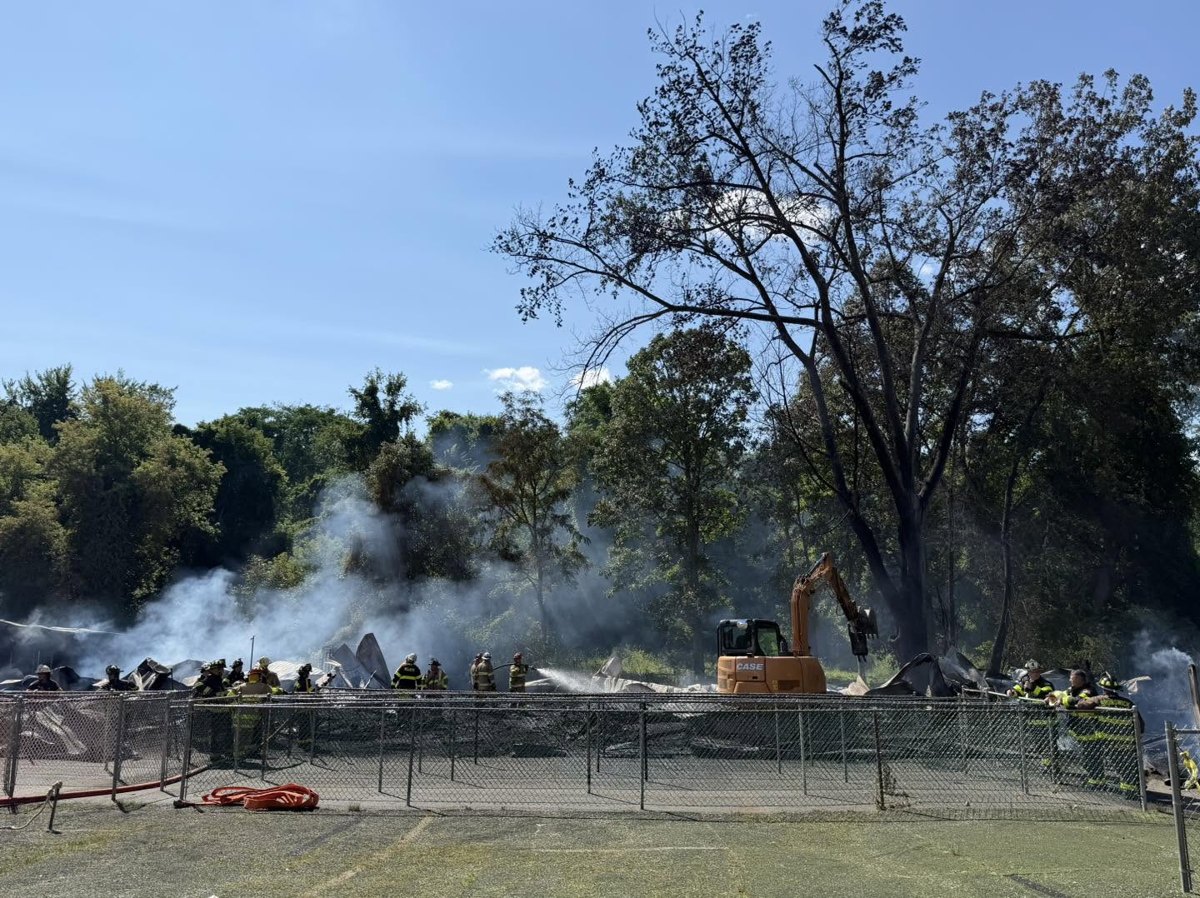 Smoldering remains of the Field of Horrors haunted house building after the July 2026 fire
