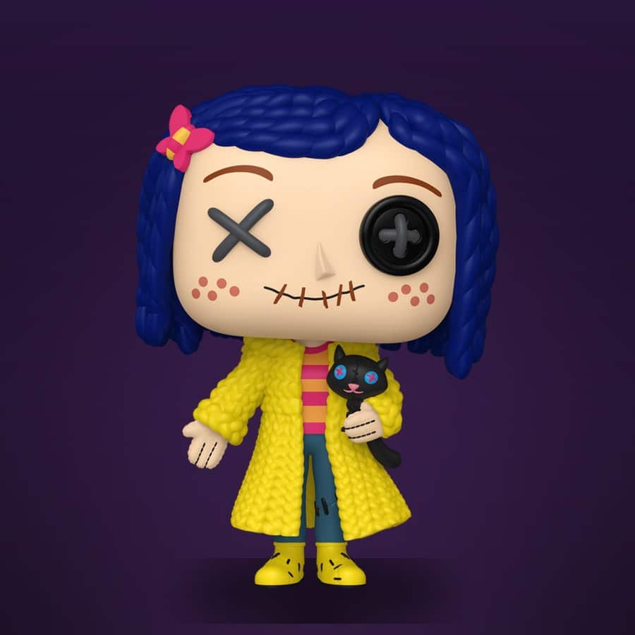 A ragdoll-style Coraline figure in a yellow raincoat with blue yarn hair, one black button eye and one stitched X, holding a black cat