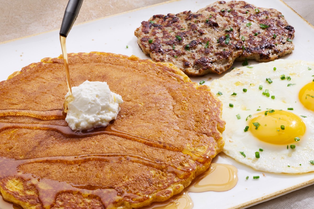 First Watch Pumpkin Pancake Breakfast with a spiced pumpkin pancake, two eggs, and chicken apple sausage