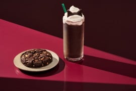 Starbucks Black Cat Frappuccino topped with chocolate cat ears beside the Venti Black Night Cookie