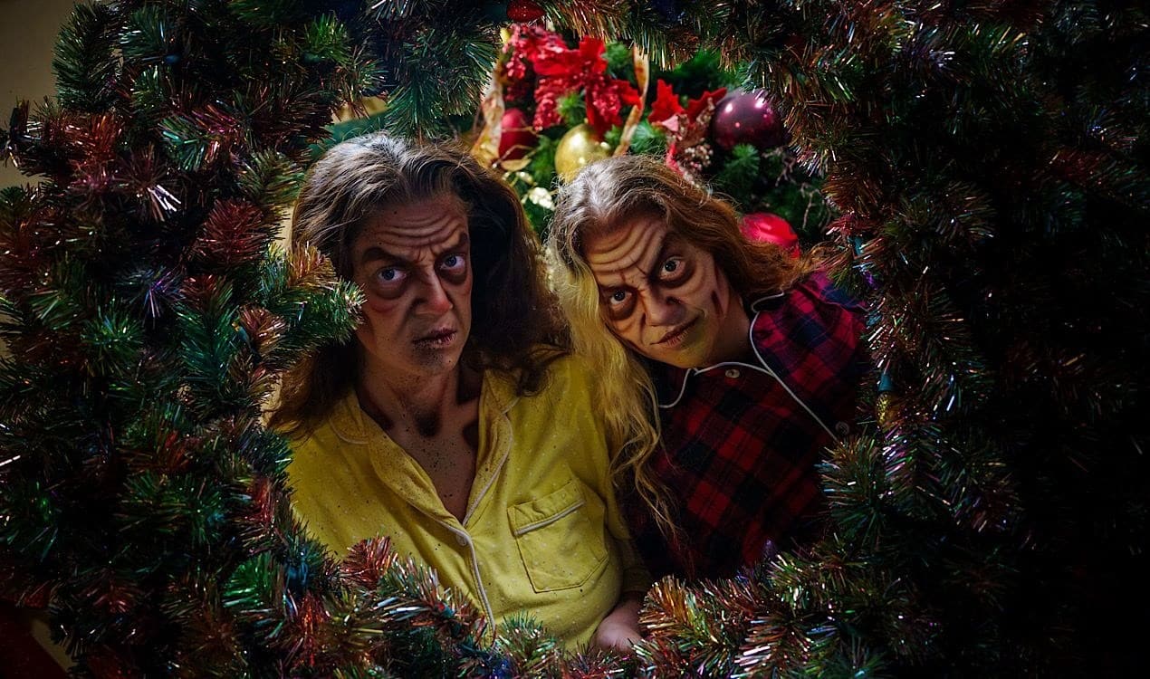 Two costumed scareactors in the Twisted Holidays maze at Six Flags Great Adventure
