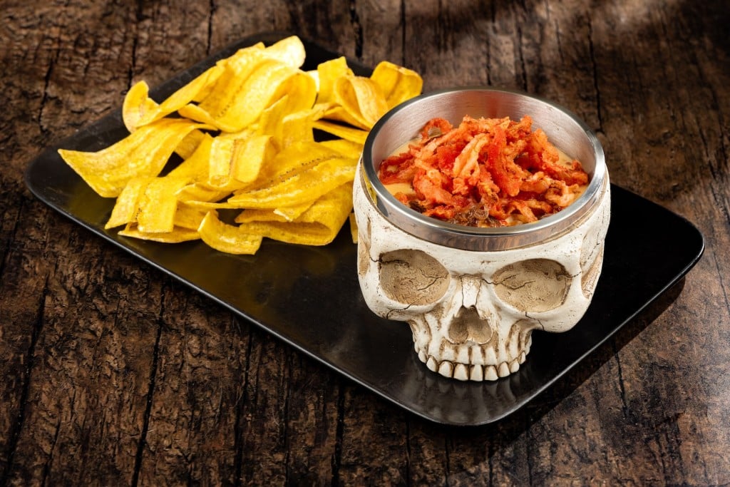 The Skull of the Dead Dip at Jock Lindsey's Hangar Bar: barbacoa beef, cheddar sauce, onion straws, and plantain chips