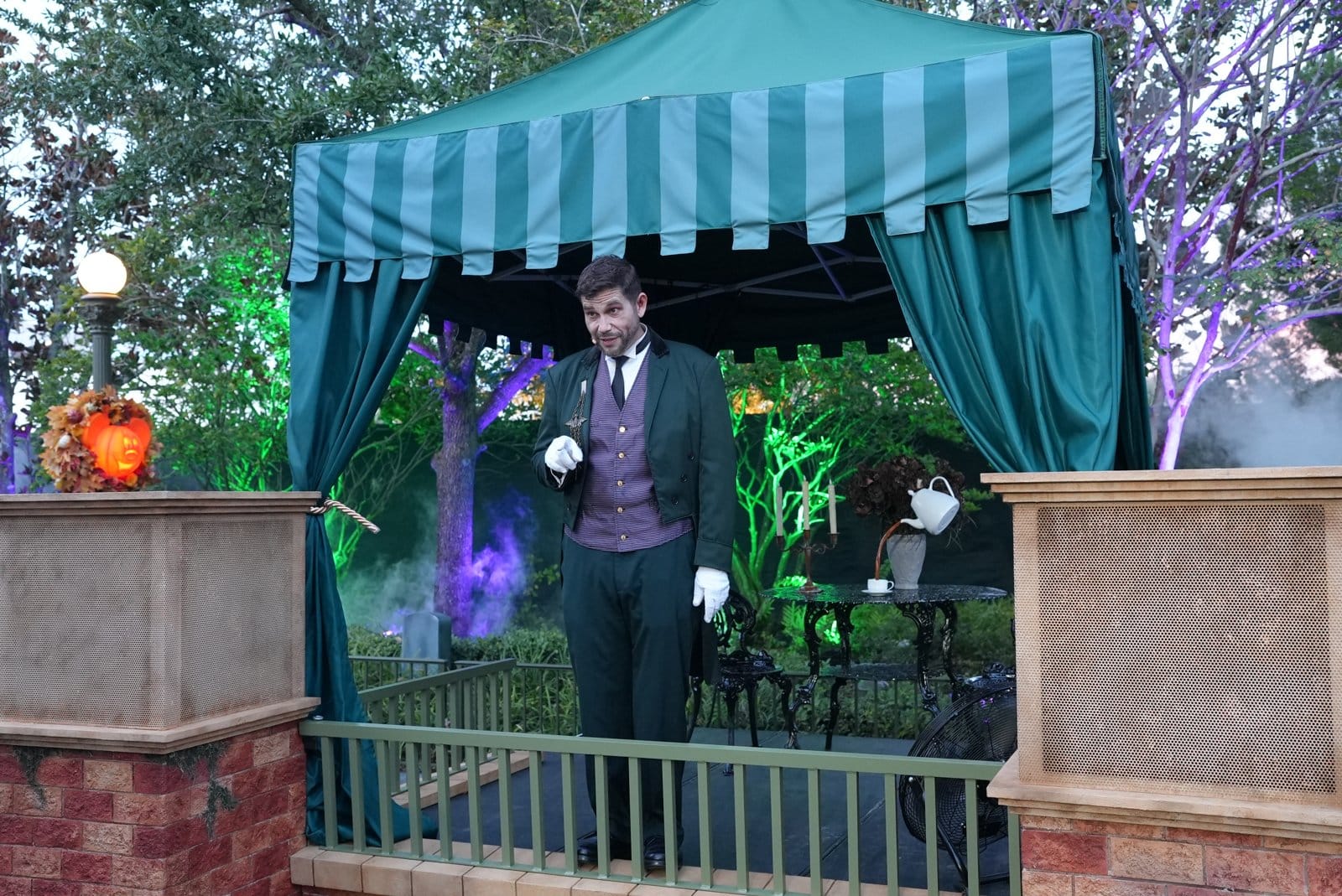 Blair Lockward, chief steward of the Haunted Mansion, under a green-striped tent