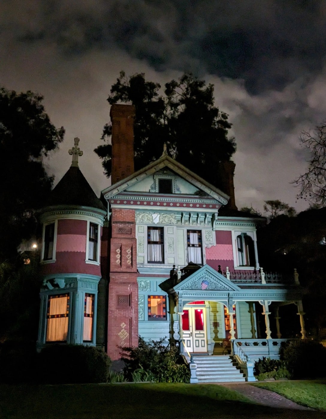 The Victorian Hale House at Heritage Square Museum, lit up at night