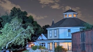 The Octagon House at Heritage Square Museum in Los Angeles, lit up at night