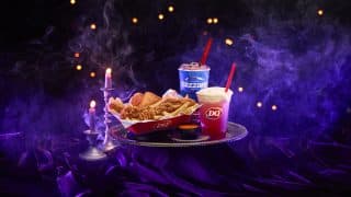 Dairy Queen's Spellbound Series Halloween menu on a silver tray: the purple Enchanted OREO Blizzard, the Bubble Brew Sparkler, and a Chicken Strip Basket with Ghost Pepper Sauce