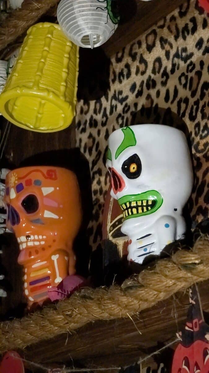 Custom tiki mugs on the bar shelf in the Bloodengutz house