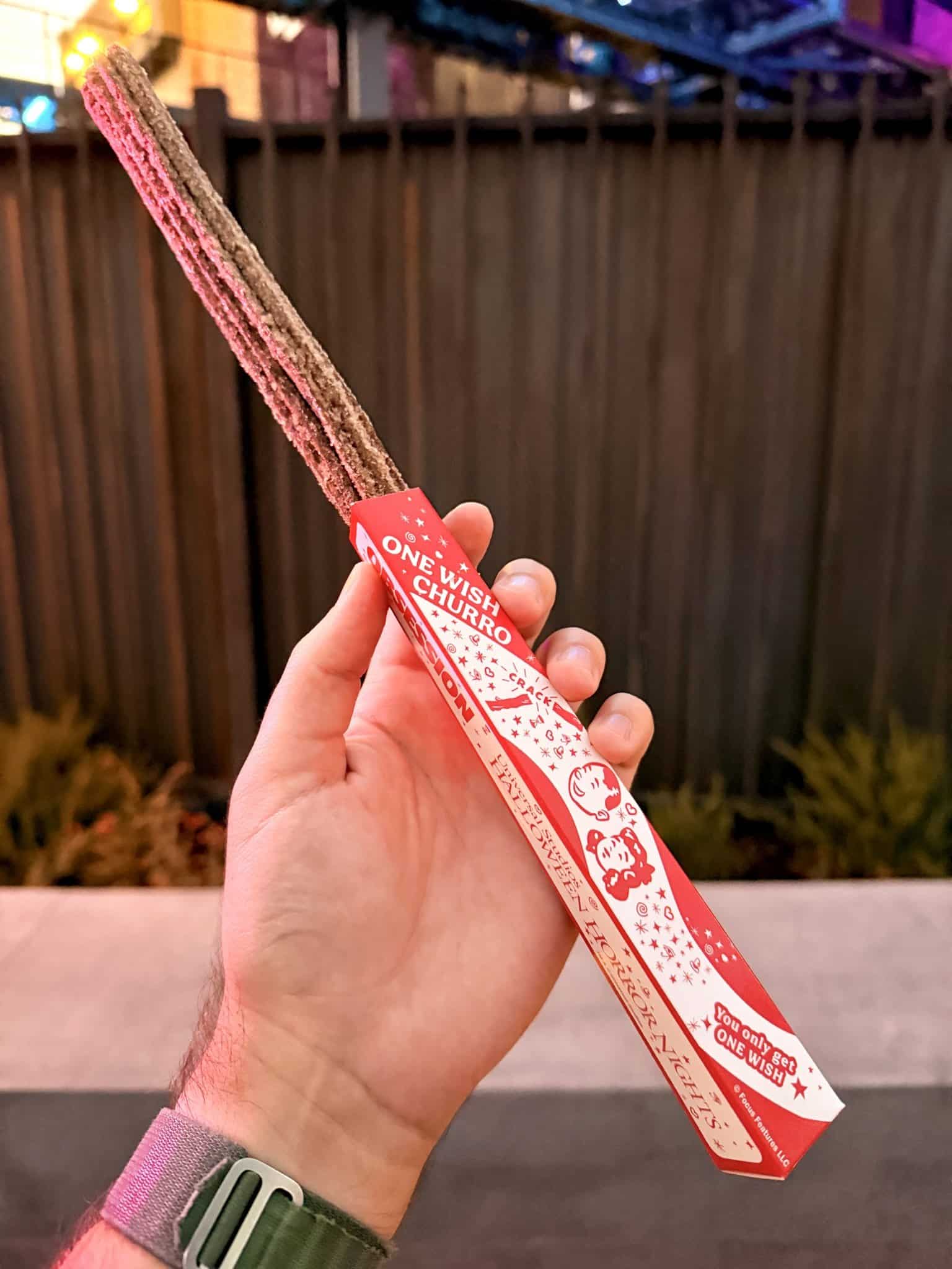 A sugar-coated chocolate One Wish Churro in its red and white Obsession box at Halloween Horror Nights Hollywood