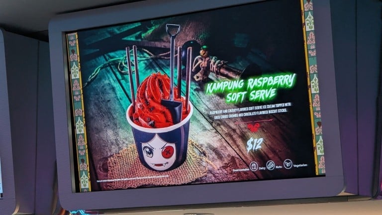 A lit menu screen picturing a cup of red soft serve with chocolate sticks and a printed name and price
