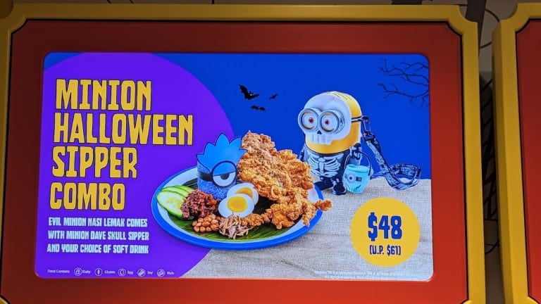 A lit menu screen in a red and yellow frame picturing a plate of blue rice with fried squid and a yellow character cup, with a printed name and price