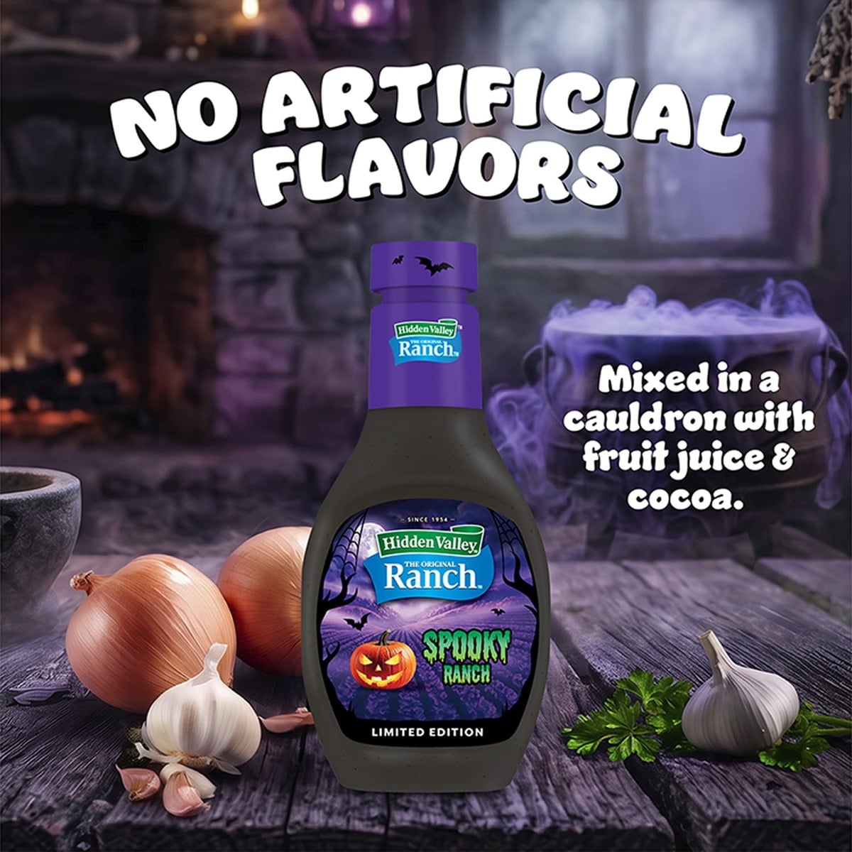 A bottle of Hidden Valley Spooky Ranch beside onions, garlic, and a bubbling purple cauldron