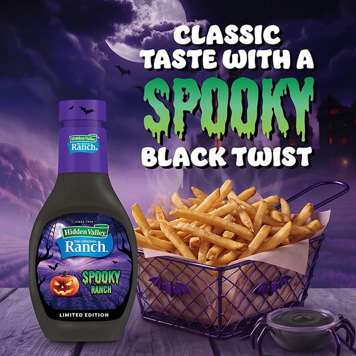 A bottle of Hidden Valley Spooky Ranch beside a basket of fries and a small dish of black ranch