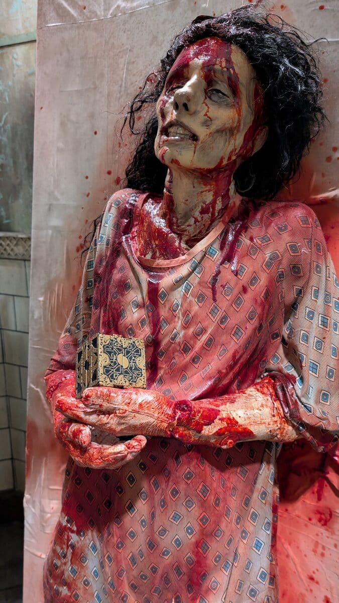 Julia prop holding a puzzle box in the HHN Hellraiser house