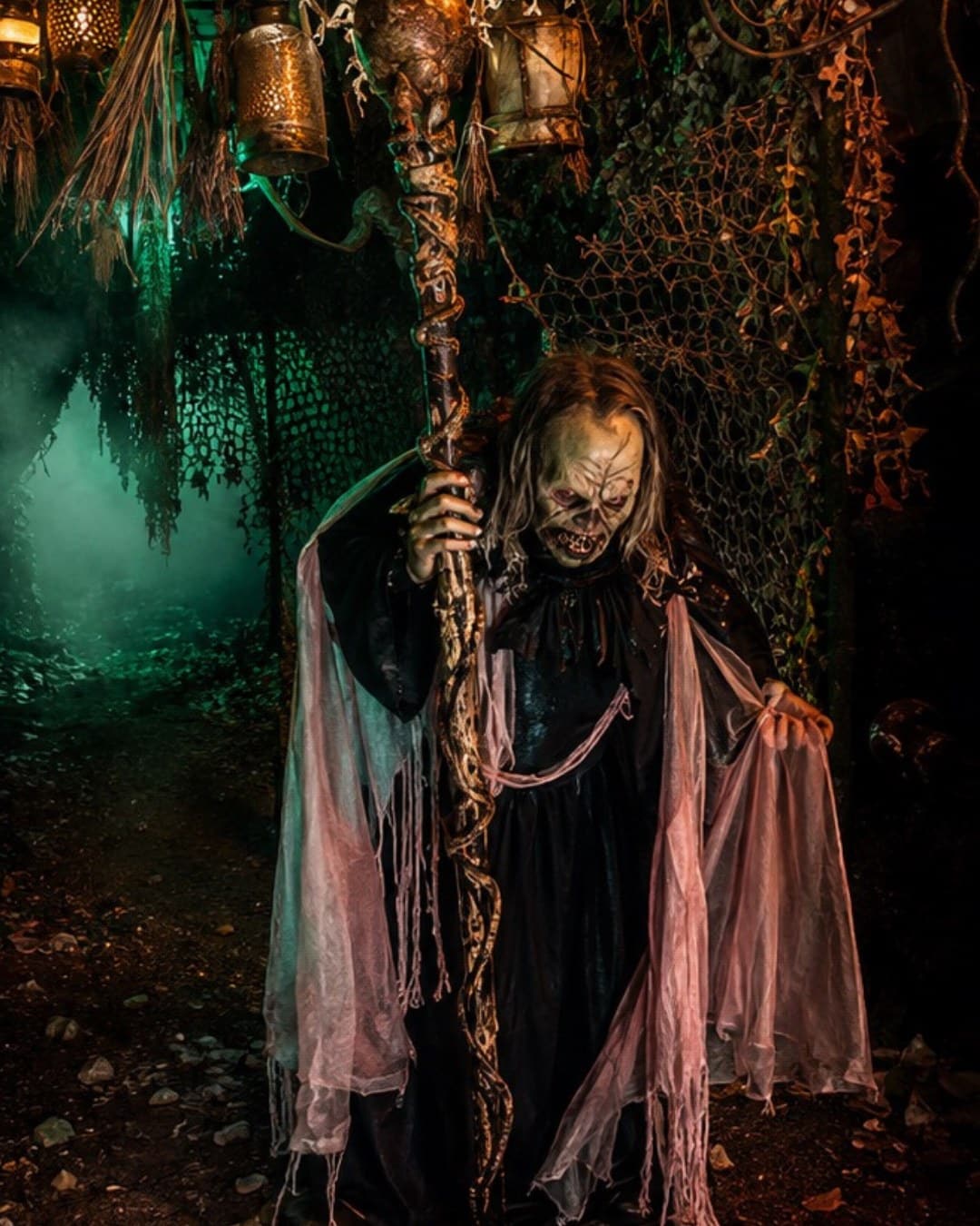 A ghoulish witch character in a fog-lit swamp scare zone at The Horrorland Miami