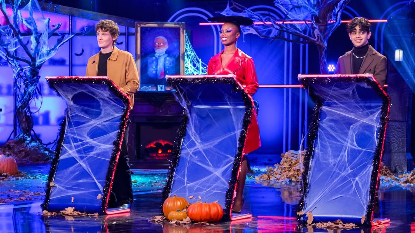 Hunter Doohan, Joy Sunday and Isaac Ordonez at the Is It Cake? Halloween judges' podiums