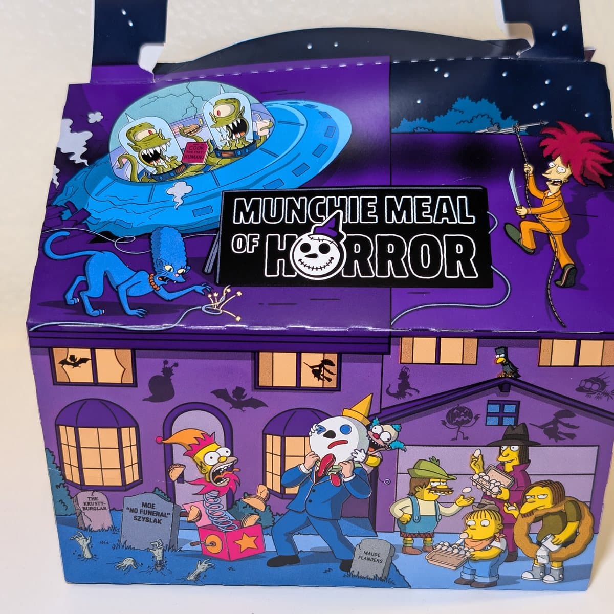 The front of the Jack in the Box Munchie Meal of Horror box with Kang and Kodos and Sideshow Bob
