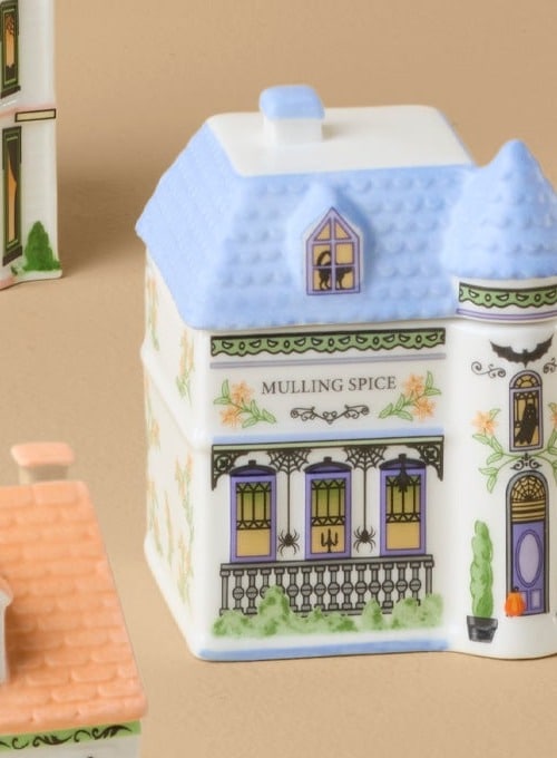 Close-up of the Lenox Spice Village Halloween mulling spice jar, a turreted manor with spiders in the windows