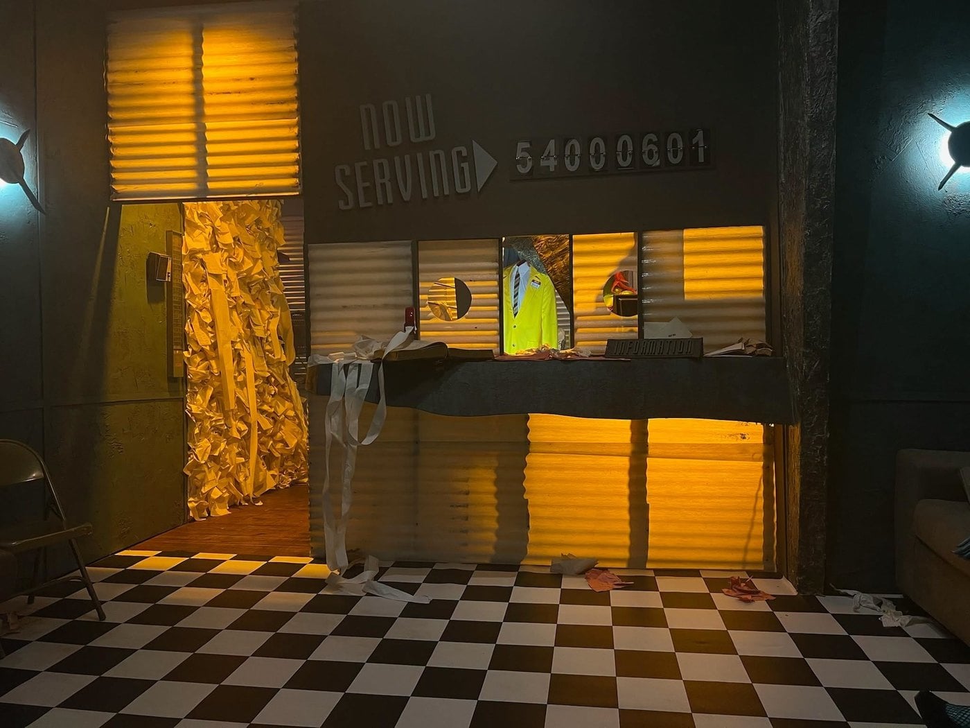 A service counter under a Now Serving sign, with paper spilling onto a checkered floor, in The Lucky Rabbit's Beetlejuice walkthrough