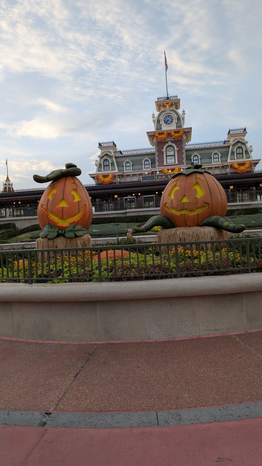 Jack-o'-lantern displays in front of the Main Street, U.S.A. train station at Magic Kingdom in August 2026