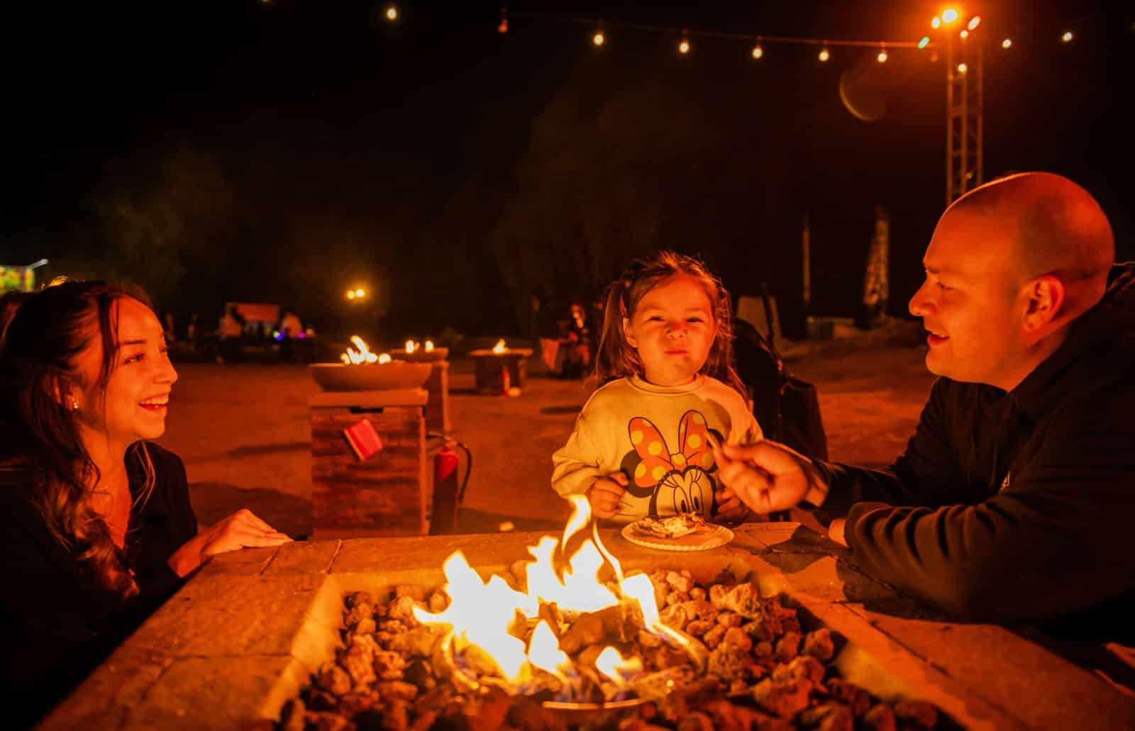 A family makes s'mores at Magic of the Jack O'Lanterns