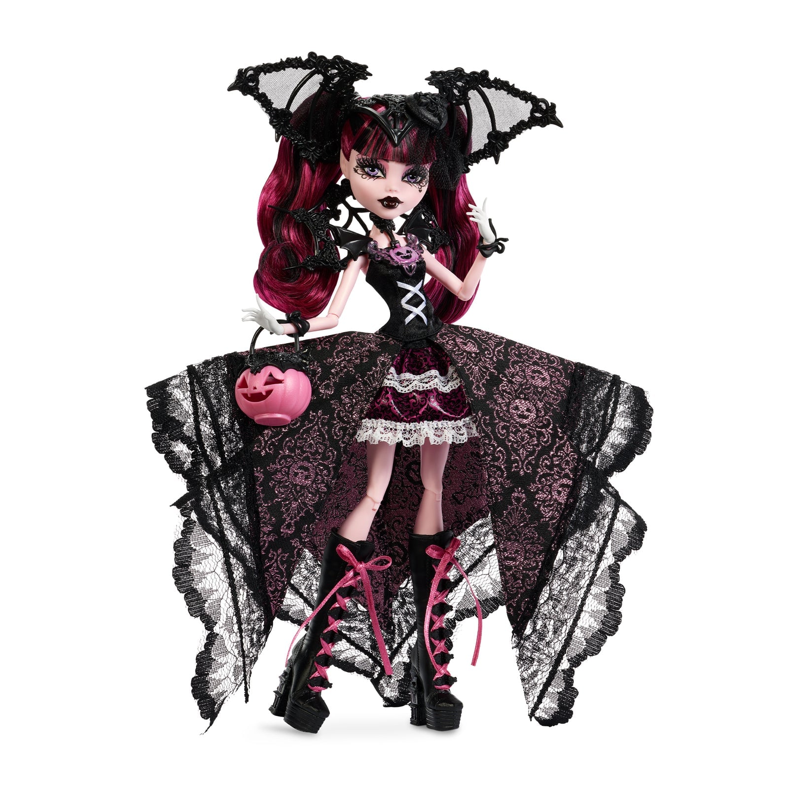 A doll with black and pink hair, a black batwing headpiece and a black-and-pink lace gown, holding a pink jack-o'-lantern purse