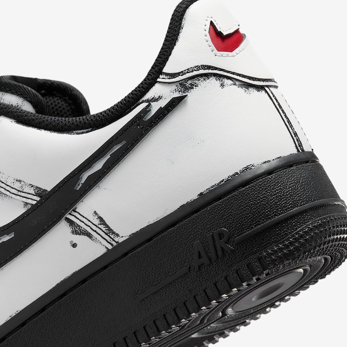 The heel of the white Air Force 1 with a slashed red Swoosh and black brushed outlines