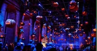 The Great Hall under a ceiling of floating jack-o-lantern pumpkins during Nox at Warner Bros. Studio Tour London