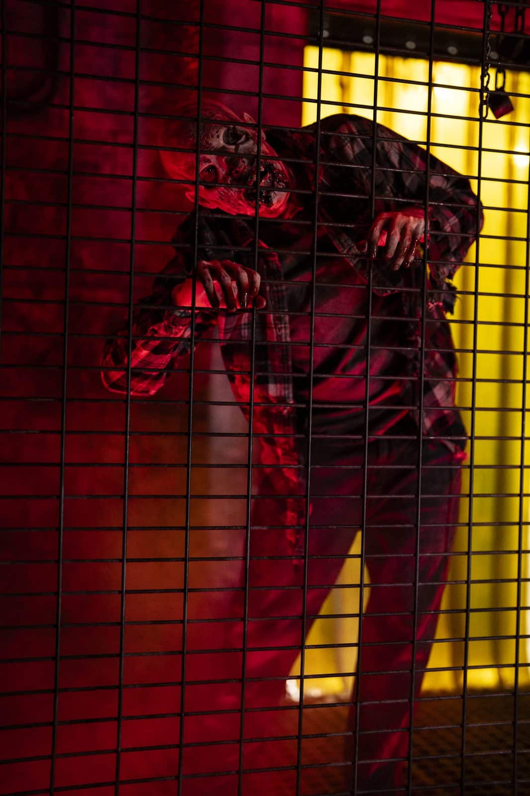 A zombie behind a cage grate at the Resident Evil takeover at Universal Horror Unleashed