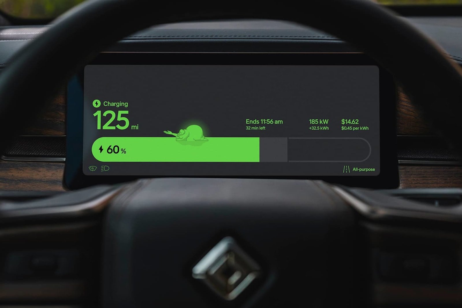 A driver display behind a steering wheel shows a green charging bar with a small green ghost lying on top of it