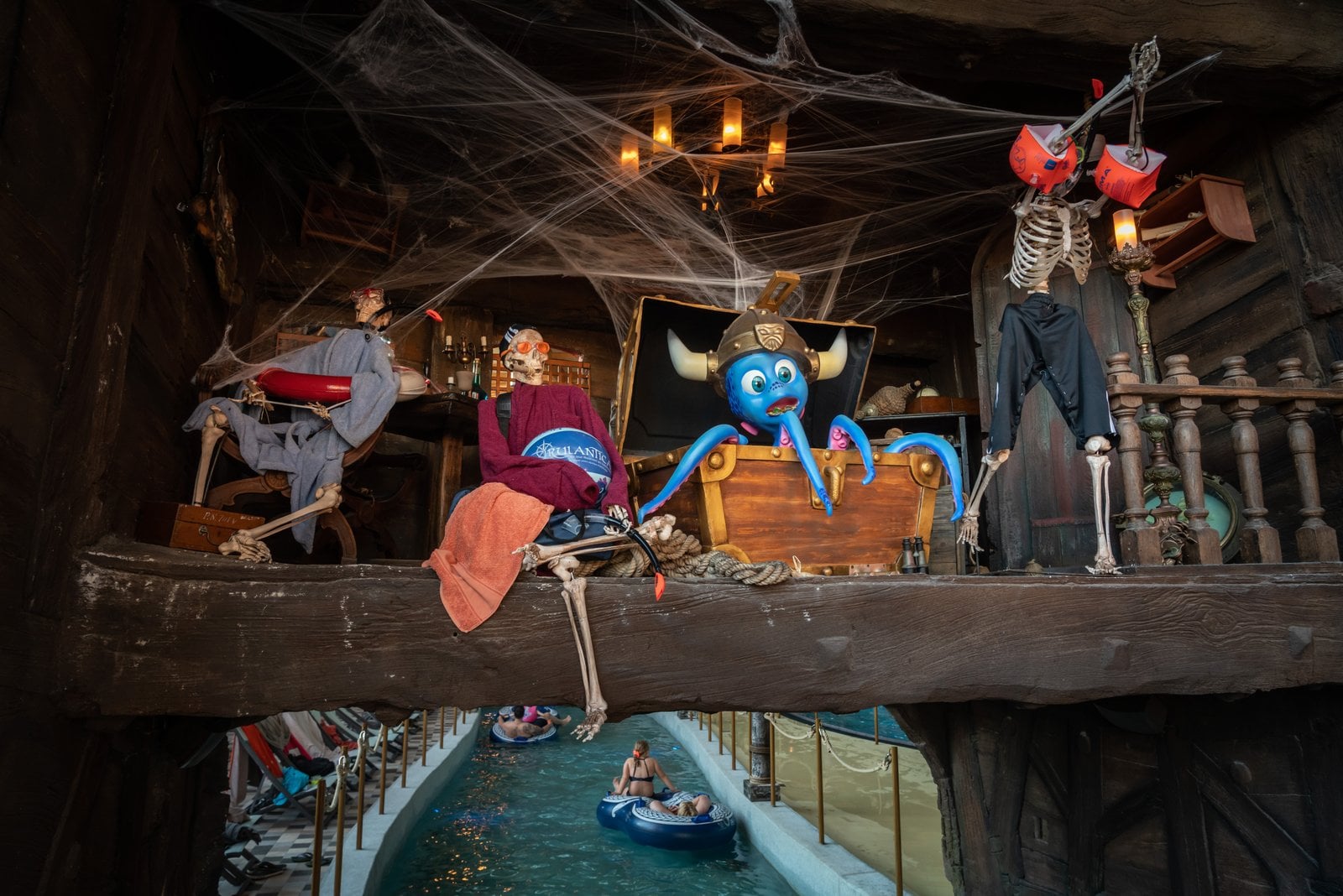 Skeletons and Halloween decorations over the lazy river at Rulantica water world