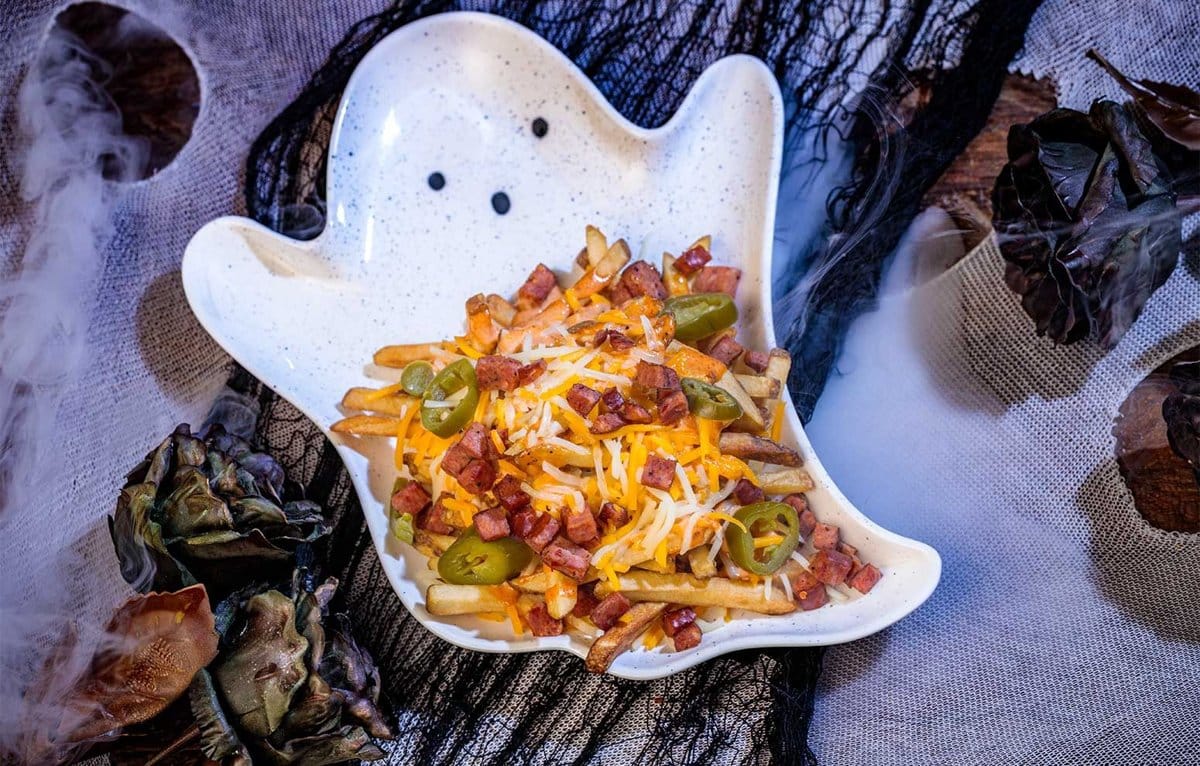 Loaded fries with cheese and jalapeños on a ghost-shaped platter