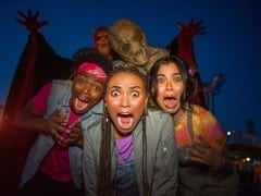 Guests scared by monsters at Fright Fest at Six Flags Magic Mountain