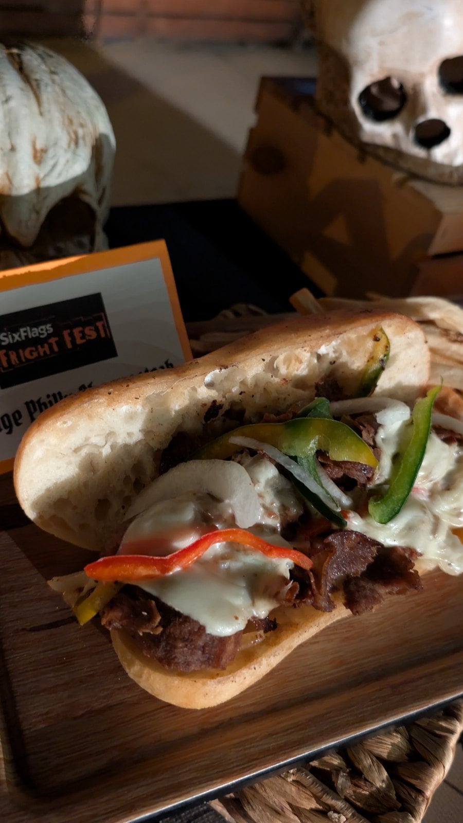 Carnage Philly Cheesesteak with sliced steak, bell peppers, and melted cheese on Philly bread
