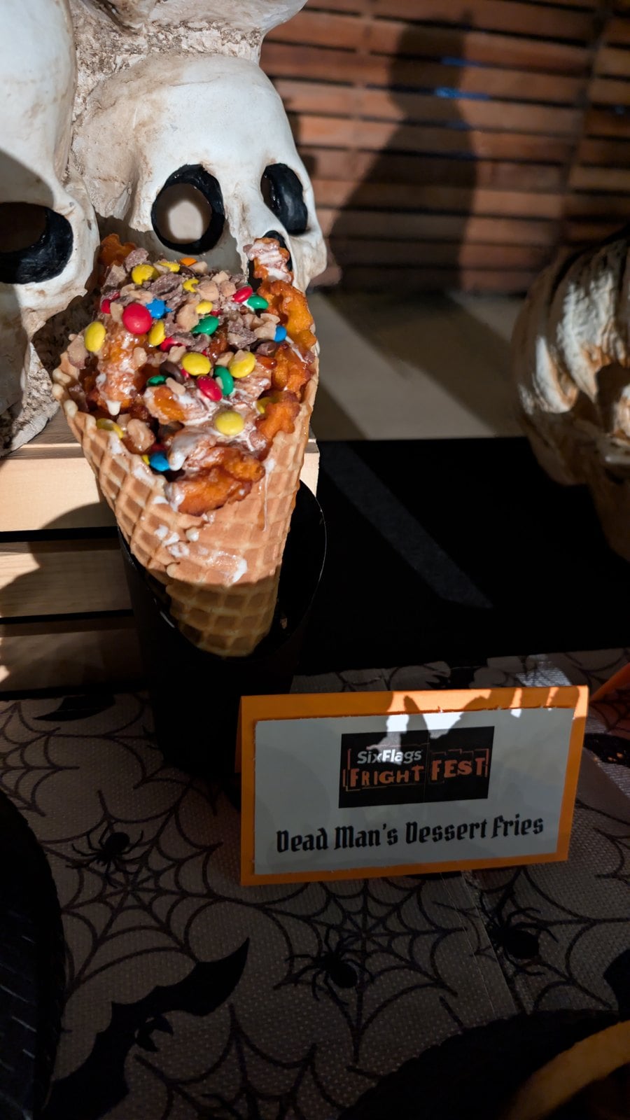 Dead Man's Dessert Fries in a waffle cone with marshmallow topping, caramel, Heath pieces, and M&M'S