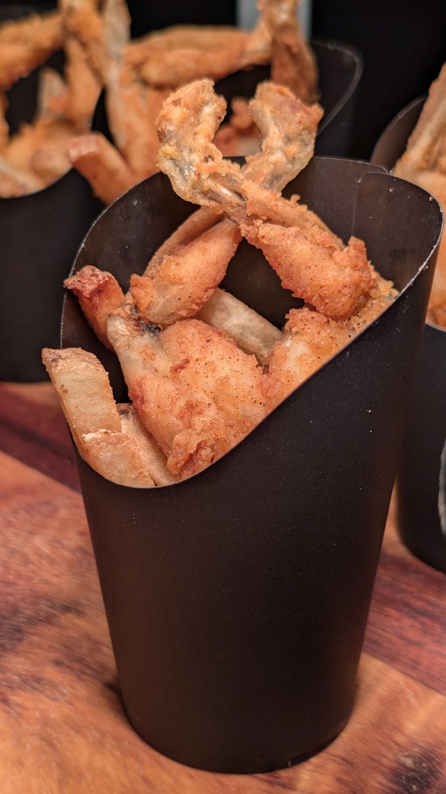 Cajun-seasoned Last Leap Frog Legs in a black cup at Six Flags Magic Mountain Fright Fest