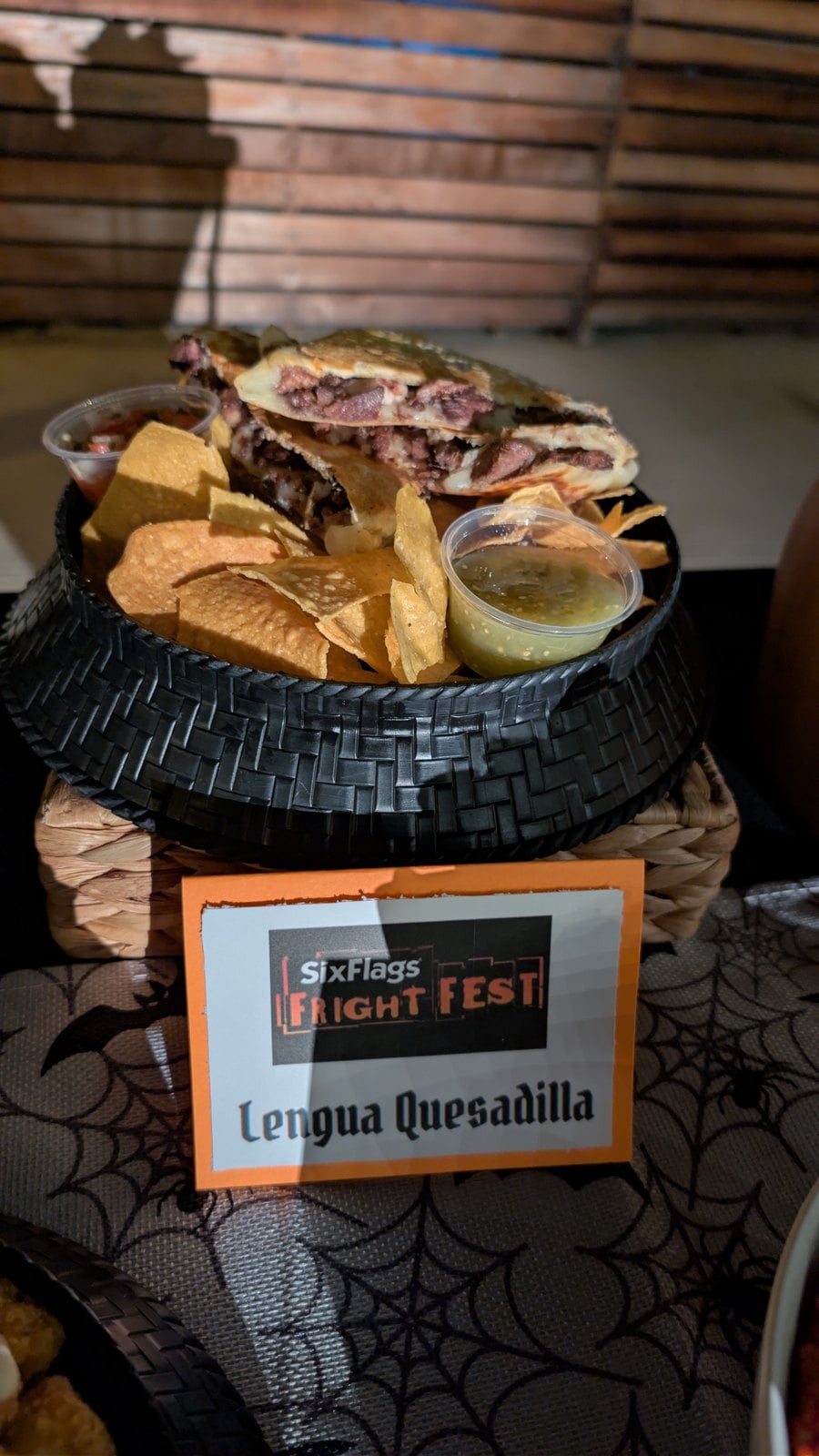 Lengua Quesadilla with tortilla chips and a cup of salsa verde